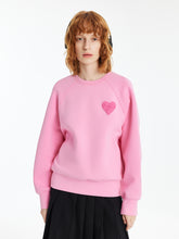 A lady wears a pink shirt.